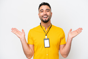 Young Arab man with ID card isolated on white background with shocked facial expression