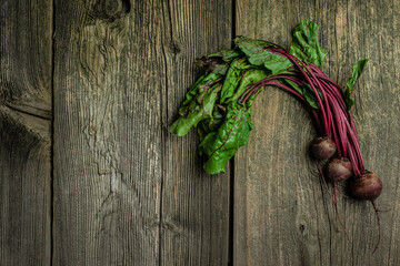 Raw beetroot with herbage leaves on a dark background. banner, menu, recipe place for text, top view