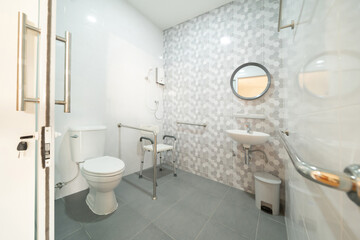 Public handicap toilet for disable people. Men bathroom doors in restroom in restaurant or hotel or...
