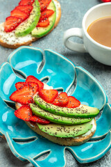 Crostini or toasts with strawberries and cream cheese ricotta. Delicious breakfast or snack, Clean eating, dieting, vegan food concept. top view