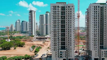 Bat-Yam, Israel, July 11, 2022.Aerial view of the construction of new comfortable apartments on the Mediterranean coast in Israel. The new residential area of skyscrapers. High-quality 4k footage