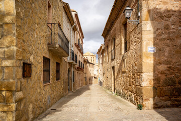 a street with traditional houses in Monteagudo de las Vicarias town, province of Soria, Castile and León, Spain