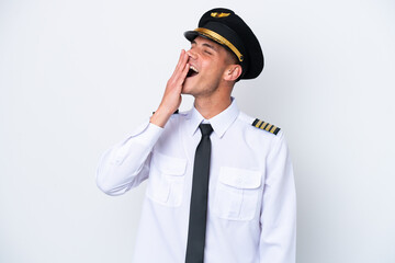 Airplane caucasian pilot isolated on white background yawning and covering wide open mouth with hand