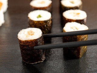Japanese kitchen. Sushi on a dark background.