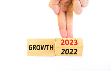 Planning 2023 growth new year symbol. Businessman turns a wooden cube and changes words Growth 2022 to Growth 2023. Beautiful white background, copy space. Business 2023 growth new year concept.