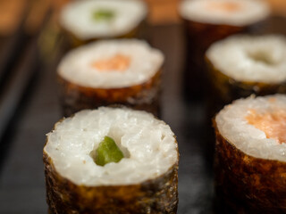 Japanese kitchen. Sushi on a dark background.