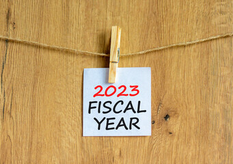 2023 fiscal year symbol. White paper with words 2023 Fiscal year, clip on wooden clothespin....