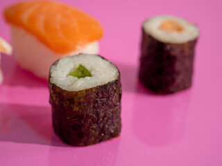 Japanese kitchen. Sushi on a pink background.