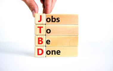 JTBD jobs to be done symbol. Concept words JTBD jobs to be done on wooden blocks on beautiful white...