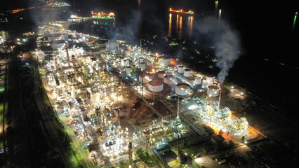 Aerial drone night shot of illuminated industrial crude oil refinery near area of Isthmus canal,...