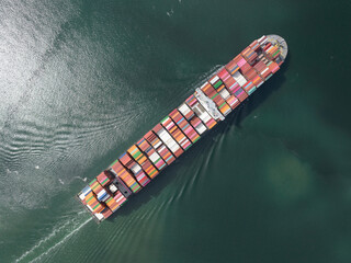 Container cargo ship, bulk transport of sea containers. Top down aerial of a commercial global...