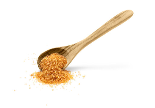 Brown cane sugar in wooden spoon on white background