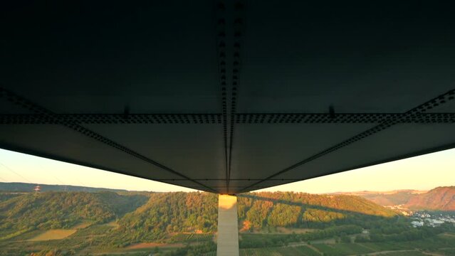 Pan down underside of the Moseltal bridge near Koblenz Germany during sunrise