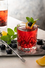 Berry drink with fresh blueberries and mint, berry ice lemonade in a glass