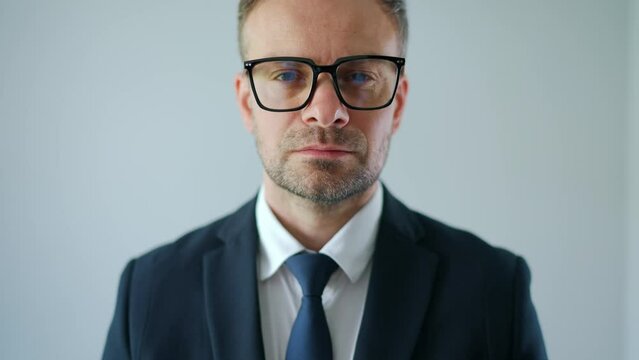 Portrait of a formally dressed man looking at the camera