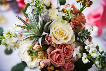 Floral arrangement at a wedding with roses and succulents