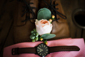 Groom's boutonniere with watch and tie flatlay