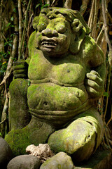 Mossy stone statue in the Sacred Monkey Forest Sanctuary in Ubud, Bali