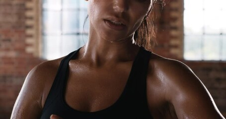 Hands, gym and fitness of a woman in sweat after intense workout taking off hand bandages. Fit, sweaty and young female athletic boxer or fighter done with sports training or exercise in a studio. - Powered by Adobe