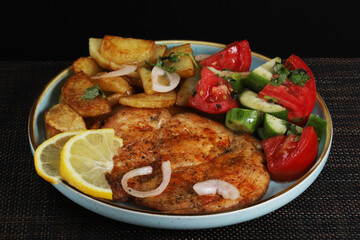 Langet, chop with vegetables on the sides. Shallow depth of field