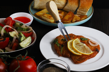 Langet, chop with vegetables on the sides. Shallow depth of field