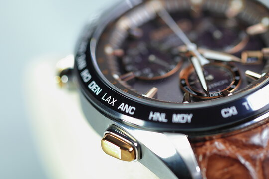 close up shallow focus Time zone cities code on luxury world time watch bezel on LAX Los Angeles.