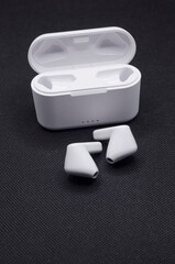 High angle view of wireless stereo earbuds black and charging case