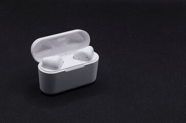 High angle view of wireless stereo earbuds and charging case