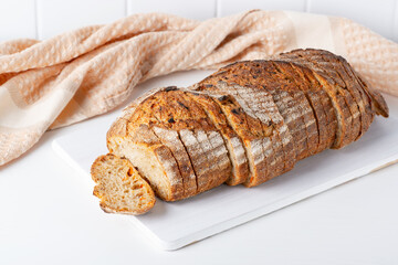 Fresh bread with carrots on the white table