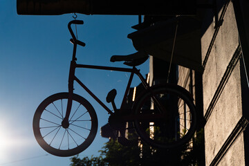 Fototapeta na wymiar Copenhagen, Denmark A bike hanging from a sign at a bike store.