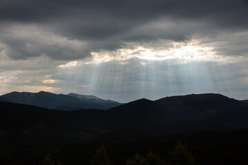 Radiating evening sun Through the Clouds in the mountains, with view on Dovbushanka mountain range