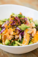 Shrimp salad, avocado, red cabbage, lettuce, carrot and passion fruit