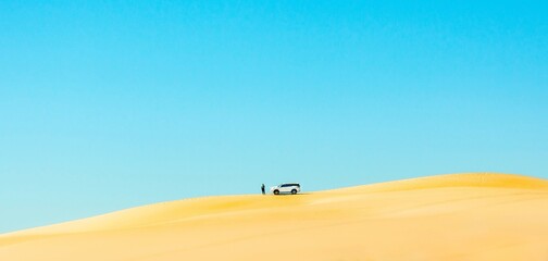 Naklejka na ściany i meble Car on top of sand dune