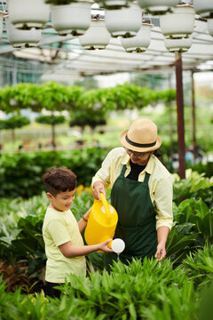 Mother and Son Watering Plants