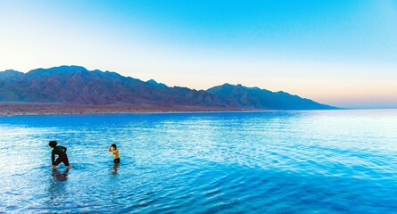 Two children playing in the sea in Tabuk, Saudi Arabia.