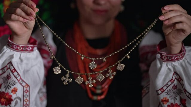Ukrainian woman demonstrating authentic traditional jewelry necklace of Ukraine - Zgarda - archaic hutsul neck ornament of status religious purpose