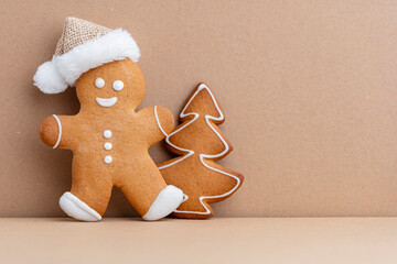 Gingerbread man, cookies and Christmas decor on pastel background.