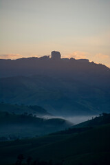 MOUNTAIN AND HILLS WITH FOG AT SUNRISE