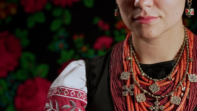 Authentic woman in traditional ukrainian jewelry necklace and costume. Lady in national costume - vyshyvanka and ancient coral beads, Zgarda - archaic hutsul neck ornament of status religious purpose