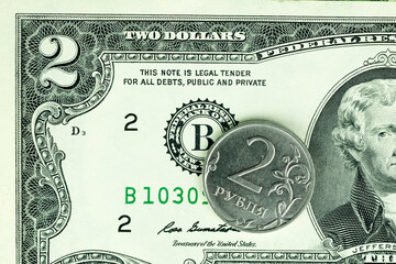 Ruble coin on background of USA dollar bill, Russian ruble money is under sanctions. Concept of economy crisis, finance of Russia, currency exchange rate, inflation, politics and ruble payment.