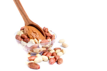 Peanuts with peanut paste in a wooden spoon. Isolated on a white background.