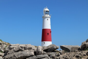 Fototapeta na wymiar The distinctive red and white striped lighthouse at Portland Bill in Dorset, England