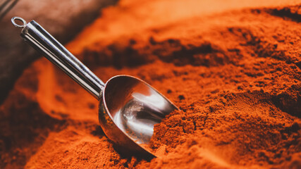 Ground chili pepper, paprika, powdered paprika in spoon, selective focus