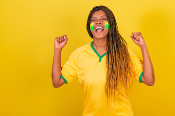 young brazilian soccer fan woman. celebrating, vibrating. Brazil soccer team.