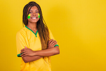 black woman young brazilian soccer fan. arms crossed, confident, happy, joyful.