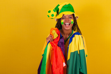 black woman cheerleader, holding brazil flag and lgbt flag, lgbt pride, diversity. female empowerment.