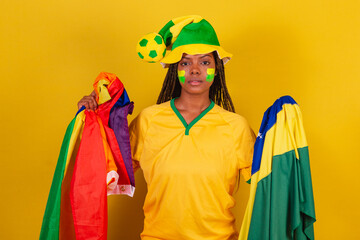 black woman cheerleader, holding brazil flag and lgbt flag, lgbt pride, diversity. female empowerment.