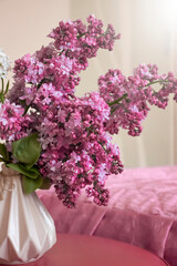 Beautiful bouquet of blooming lilacs in the room