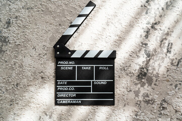 movie clapper clapboard on a grey background, shadow light effects, film making, start camera...