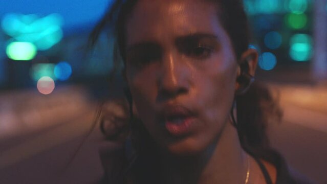 Fast running, endurance and intense training with closeup sweating woman face crossfit athlete in urban city street landscape at night time. Sports, motivation and goals with energy cardio workout